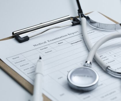 Medical examination report stethoscope white desktop 420x350